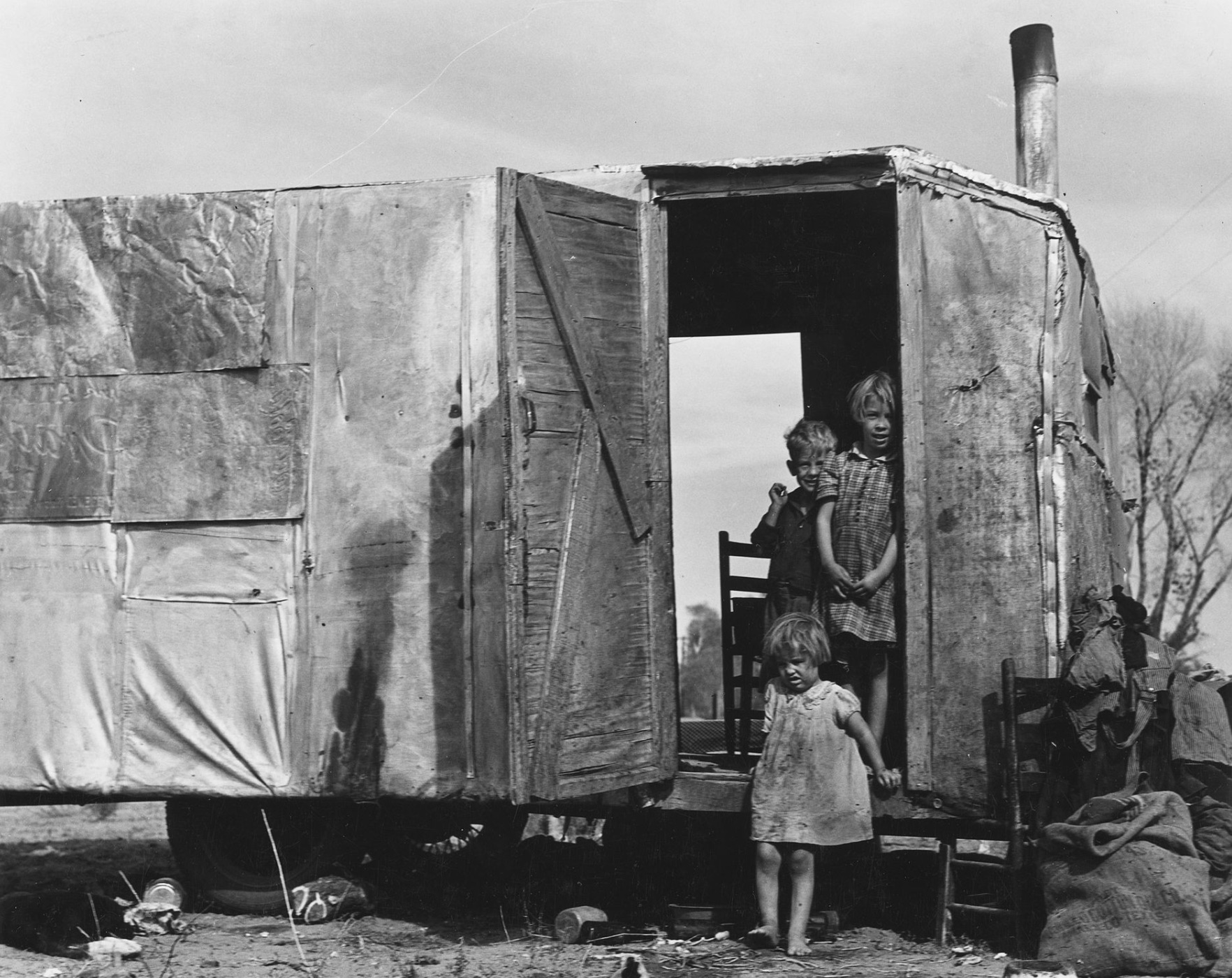 A migratory family from Texas living in a trailer in an Arizona cotton field 